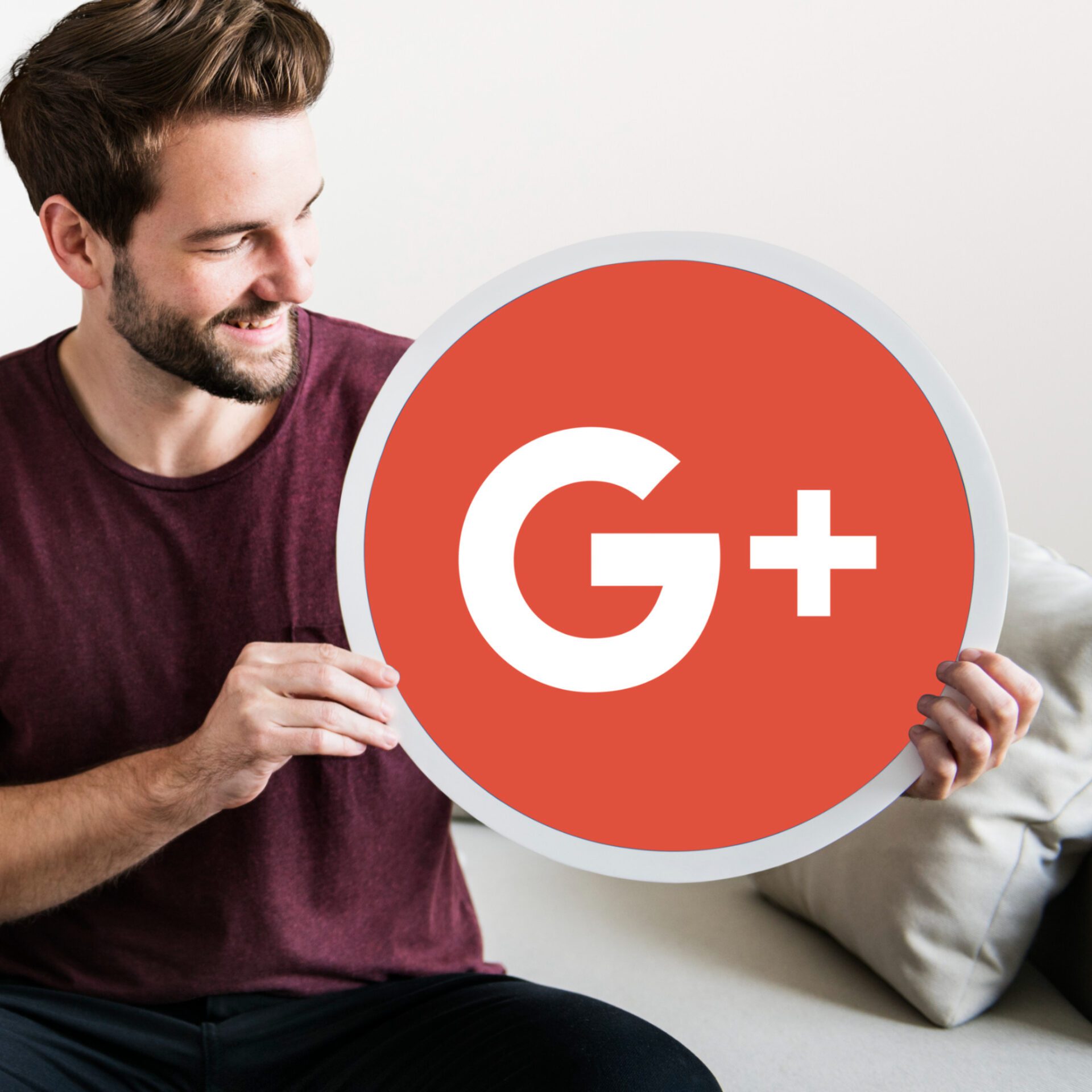 Person holding a Google Plus icon Person holding a Google Plus icon